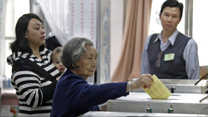 An elderly voter casts her ballot at a polling station in Taipei, Taiwan, Saturday, Jan. 14, 2012. Taiwanese voted Saturday in a closely fought presidential election that pits incumbent Ma Ying-jeou's vision of better relations with China against his main challenger's attempts to galvanize resentment over growing income inequality. (AP Photo/Vincent Yu)