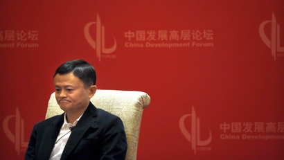 In this March 19, 2016 photo, Jack Ma, executive chairman of the Alibaba Group, listens to a speaker during a panel discussion held as part of the China Development Forum at the Diaoyutai State Guesthouse in Beijing. The International Anti-Counterfeiting Coalition's decision to welcome Chinese e-commerce giant Alibaba as a new member - and allow founder Jack Ma to make the keynote speech at its May 2016 conference - so incensed the U.S. luxury retailer Michael Kors that it severed its longstanding connection with the Washington-based industry group.