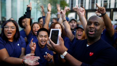 DATE IMPORTED:September 16, 2016A customer celebrates with Apple workers after buying a new iPhone