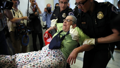 People are removed from a sit-in outside of Senate Majority Leader Mitch McConnell's office as they protest proposed cuts to Medicaid, Thursday, June 22, 2017 on Capitol Hill in Washington.