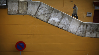 A man climbs up stairs in the Triana city quarter of the Andalusian capital of Seville