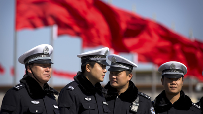 Chinese policemen gather on Tiananmen Square before delegates arrive for the opening session of the Chinese People's Political Consultative Conference in Beijing's Great Hall of the People, Tuesday, March 3, 2015. The more than 2,000 members of China's top legislative advisory body convened their annual meeting Tuesday, kicking off a political high season that will continue with the opening of the national congress later in the week. (AP Photo/Mark Schiefelbein)