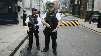 Armed police officers pose for the media in Downing Street, central London.