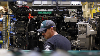 In this March 26, 2014 picture, Ed Carbaugh prepares to install parts on a truck engine on an assembly line at Volvo Trucks' powertrain manufacturing facility in Hagerstown, Md. The Federal Reserve reports on industrial production for April on Thursday, May 15, 2014. (AP Photo/Patrick Semansky)
