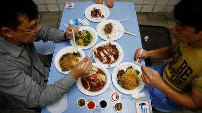 People eating street food in Singapore