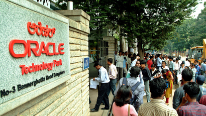 Indian graduates stand outside software company Oracle
