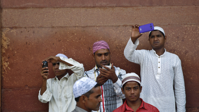 Muslims use their mobile phones after offering Eid al-Adha prayers at the Jama Masjid (Grand Mosque) in the old quarters of Delhi October 6, 2014. Muslims around the world celebrate Eid al-Adha by the sacrificial killing of sheep, goats, cows and camels to commemorate Prophet Abraham's willingness to sacrifice his son Ismail on God's command. REUTERS/Ahmad Masood