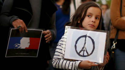Zoe Dubes, 7, attends a vigil outside the French Consulate in response to the attacks in Paris, in Los...