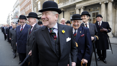 Members of one of London's oldest private members clubs, share a joke as they prepare to march around St James's Square to celebrate the 150th anniversary of the club, in London.