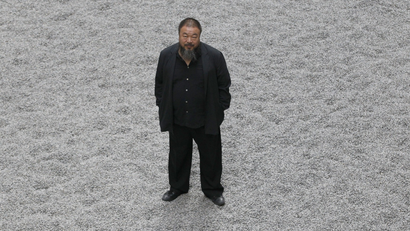 Chinese artist Ai Weiwei poses for a photograph with his new installation entitled 'Sunflower Seeds'.