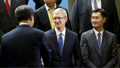Chinese President Xi Jinping (L) shakes hands with Apple Inc. CEO Tim Cook (C), as Tencent CEO Pony Ma (R) looks on, during a gathering of CEOs and other executives at Microsoft's main campus in Redmond, Washington September 23, 2015.
