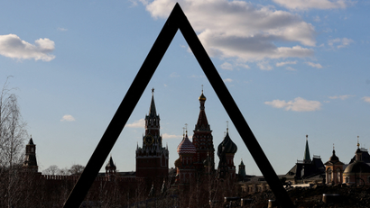 The Kremlin's Spasskaya Tower and St. Basil's Cathedral are seen through an art object in Zaryadye park in Moscow