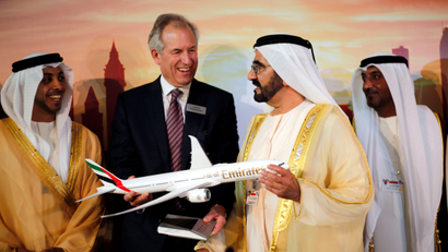 Boeing Chairman James McNerney (2nd L) shows United Arab Emirates' Prime Minister and Ruler of Dubai Sheikh Mohammed bin Rashid al-Maktoum (2nd R) a model of the new version of its 777 long-haul jet during the Dubai Airshow November 17, 2013. Boeing launched the long-awaited new version of its 777 long-haul jet with 259 orders from four airlines at the Dubai Airshow on Sunday. McNerney said the order, based on commitments worth some $100 billion at list prices, was the largest combined order in the company's history. The deal includes orders for 150 of the aircraft from Dubai's Emirates, 50 from Qatar Airways and 25 announced earlier by Abu Dhabi's Etihad Airways.