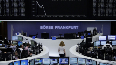 Traders are pictured at their desks in front of the DAX board at the Frankfurt stock exchange August 1, 2014. REUTERS/Pawel Kopczynski/Remote