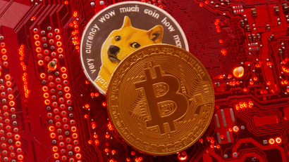 Representations of cryptocurrencies Bitcoin and Dogecoin are placed on PC motherboard in this illustration taken
