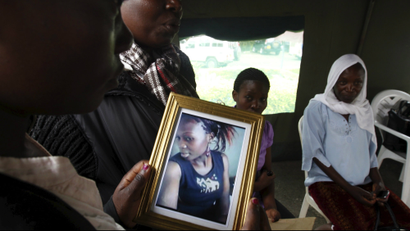 A relative carries a picture of a student killed in an attack on Garissa University in April.