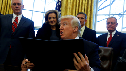 U.S. President Donald Trump signs an executive order dealing with members of the administration lobbying foreign governments, in the Oval Office at the White House in Washington, U.S. January 28, 2017.