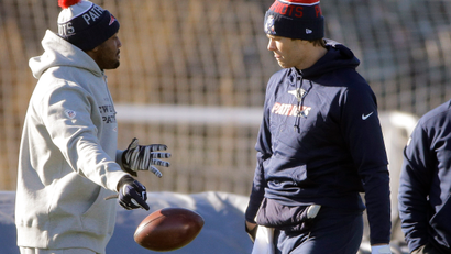 New England Patriots quarterback Tom Brady, right, walks onto the field as linebacker Dakota Watson, left, drops the ball at the start of an NFL football practice, Wednesday, Jan. 6, 2016, in Foxborough, Mass. The Patriots are to host an NFL divisional playoff game Jan. 16, 2016 in Foxborough, Mass.