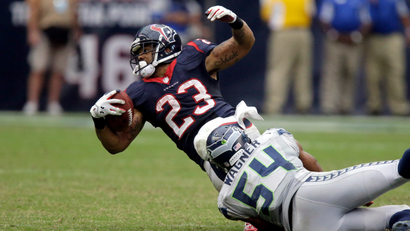 Houston Texans running back Arian Foster (23) is tackled by Seattle Seahawks middle linebacker Bobby Wagner (54) during the fourth quarter an NFL football game Sunday, Sept. 29, 2013, in Houston.