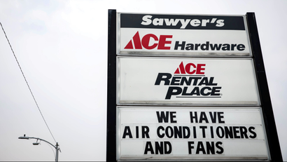 A hardware store advertises the availability of air conditioners and fans during the summer's second heat wave in The Dalles, Oregon, US