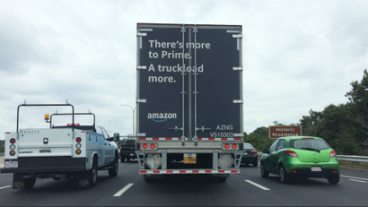 A truck on the highway carrying Amazon's goods.