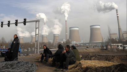 In this Dec. 3, 2009 file photo, Chinese workers take a break in front of the cooling towers of a coal-fired power plant in Dadong, Shanxi province, China. China told the United States on Wednesday, March 10, 2010, to make stronger commitments on climate change and provide environmental expertise and financing to developing nations. (AP Photo/Andy Wong
