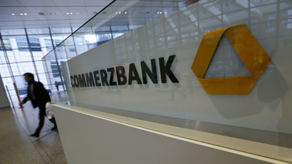 A man walks past a logo of Commerzbank ahead of the bank's annual news conference in Frankfurt.
