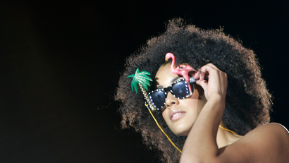 model with an afro wearing sunglasses