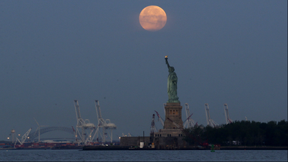 This Sunday, June 23, 2013 file photo shows a supermoon over the Statue of Liberty in New York. Monday, Nov. 14,