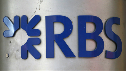 A sign in need of repair is seen outside a branch of the Royal Bank of Scotland (RBS) in the City of London