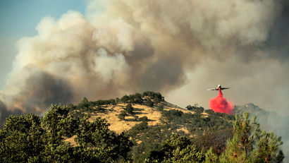 An air tanker drops retardant on a wildfire above the Spring Lakes community on Sunday, June 24, 2018., near Clearlake Oaks, Calif.