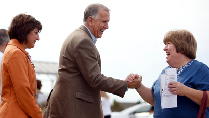 Candidate for U.S. Senate Thom Tillis (R-NC) shakes hands with a voter at a polling place during U.S. midterm elections in Charlotte, North Carolina November 4, 2014.