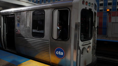 A silver Chicago CTA train at a station