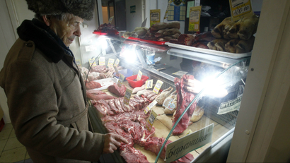 A man looks at meat on offer on a market stall in Moscow.