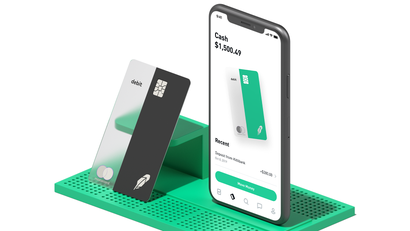 Robinhood's Mastercard debit card and a phone displaying its cash management feature
