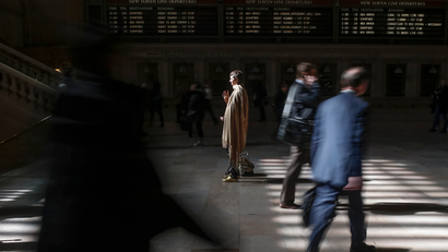 Woman stands still alone at Grand Central train Station