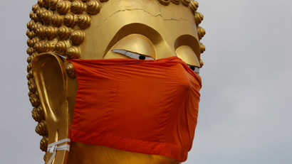 A statue of Buddha wears a face mask at a monastery following the coronavirus disease (COVID-19) outbreak in Pathum Thani, Thailand May 8, 2020.