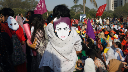 Protesters wear masks depicting Qandeel Baloch, a Pakistani social media celebrity who according to police was strangled in what appeared to be an "honour killing" in 2016, in Karachi