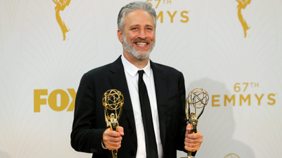 Jon Stewart holds his awards during the 67th Primetime Emmy Awards in Los Angeles