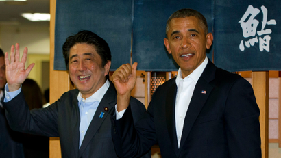 President Barack Obama and Japanese Prime Minister Shinzo Abe depart Sukiyabashi Jiro sushi restaurant inTokyo, Wednesday, April 23, 2014. President Obama begins a four-country trip through the Asia-Pacific region.