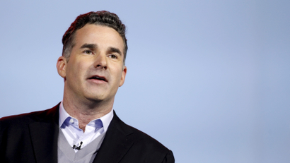 Kevin Plank in a jacket, sweater, and button-up shirt