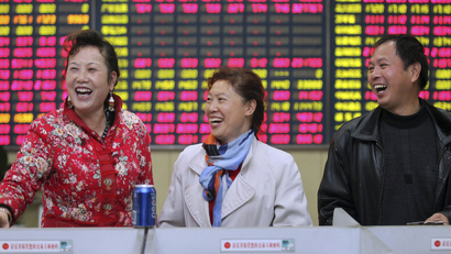 DATE IMPORTED:November 24, 2014Investors laugh in front of an electronic screen showing stock information at a brokerage house in Nantong, Jiangsu province, November 24, 2014. Chinese stocks rose, with a key index hitting a three-year high, while bond yields fell on Monday. REUTERS/China Daily