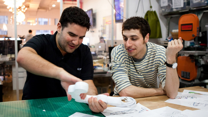 In this image released by the Sundance Channel, Ben Kaufman, founder and CEO id Quirky, left, and Jake Zien are shown working on Zien's product, an adjustable power strip called Pivot Power, in a scene from the original series, "Quirky."