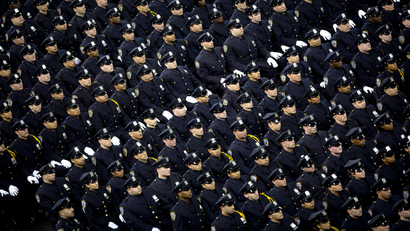 New York Police Department graduates attend their induction ceremony at Madison Square Garden in New York, December 27, 2013. The NYPD graduated 1171 recruits to ranks of police officer. REUTERS/Carlo Allegri (UNITED STATES - Tags: SOCIETY TPX IMAGES OF THE DAY) - RTX16V9L