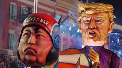 A float with effigies of North Korean leader Kim Jong Un and US president Donald Trump is paraded through the crowd during the 134th Carnival parade in Nice, France