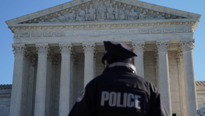 A police officer in front of the Supreme Court