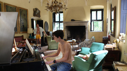 As Armie Hammer looks on, Timothee Chalamet plays inside the Villa Albergoni in "Call Me By Your Name."