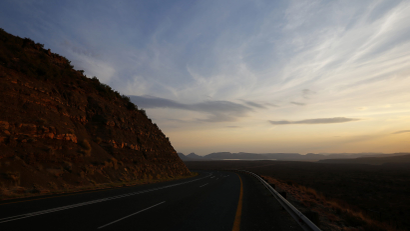 The sun sets over a road near Graaff Reinet in the Karoo October 11, 2013.