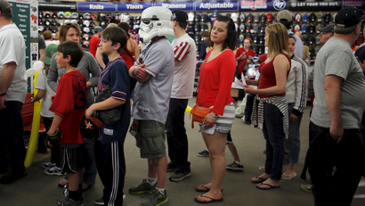 A baseball fan wearing a mask from the Star Wars movies stands in line at a souvenir store