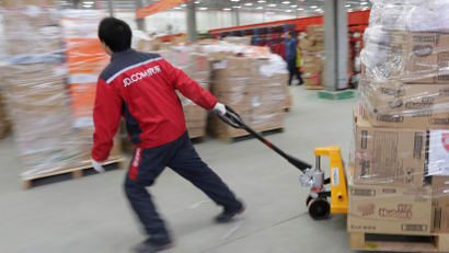A worker moves goods at a JD.com logistics centre in Langfang, Hebei province, China November 10, 2015. Picture taken November 10, 2015.